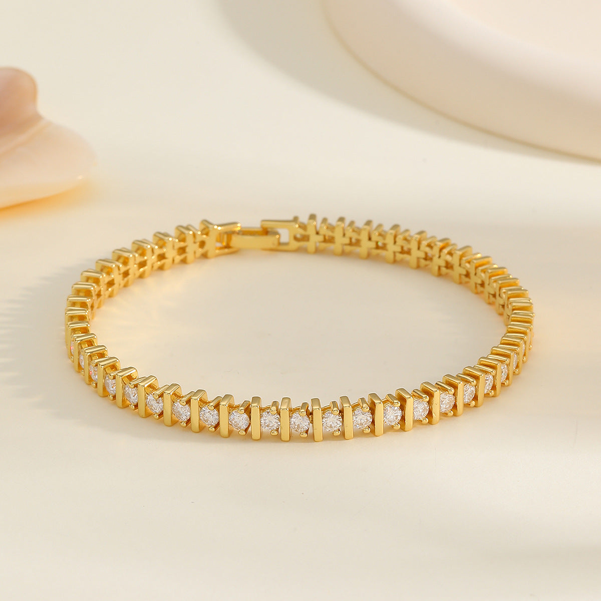 Jewelhalo gold moissanite tennis bracelet on cream satin