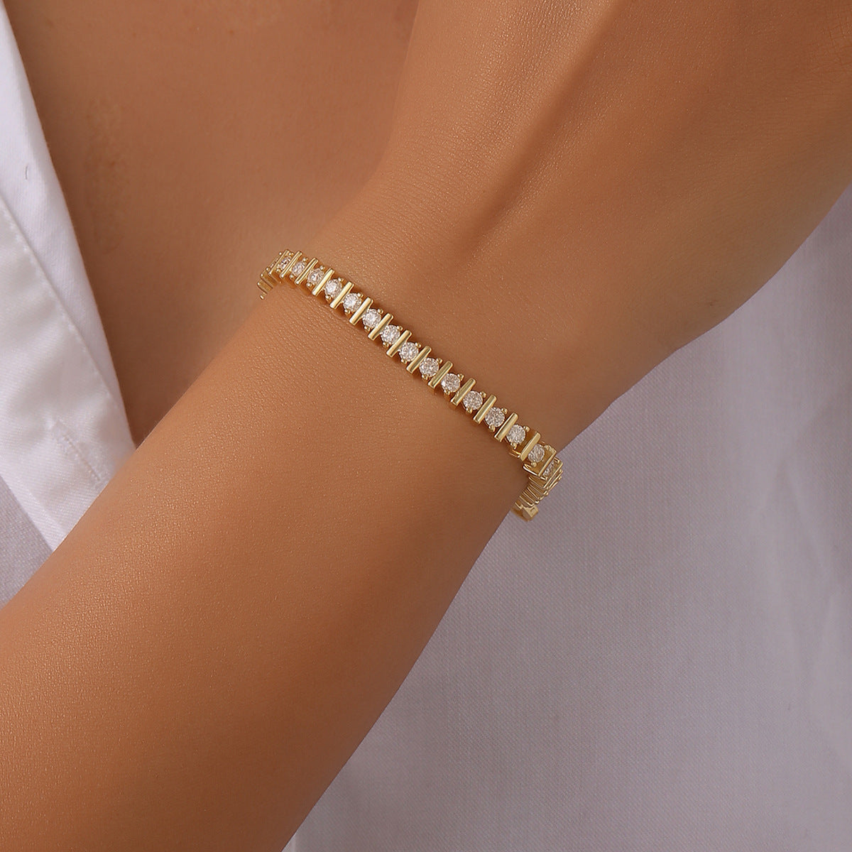 Jewelhalo gold moissanite tennis bracelet worn on wrist