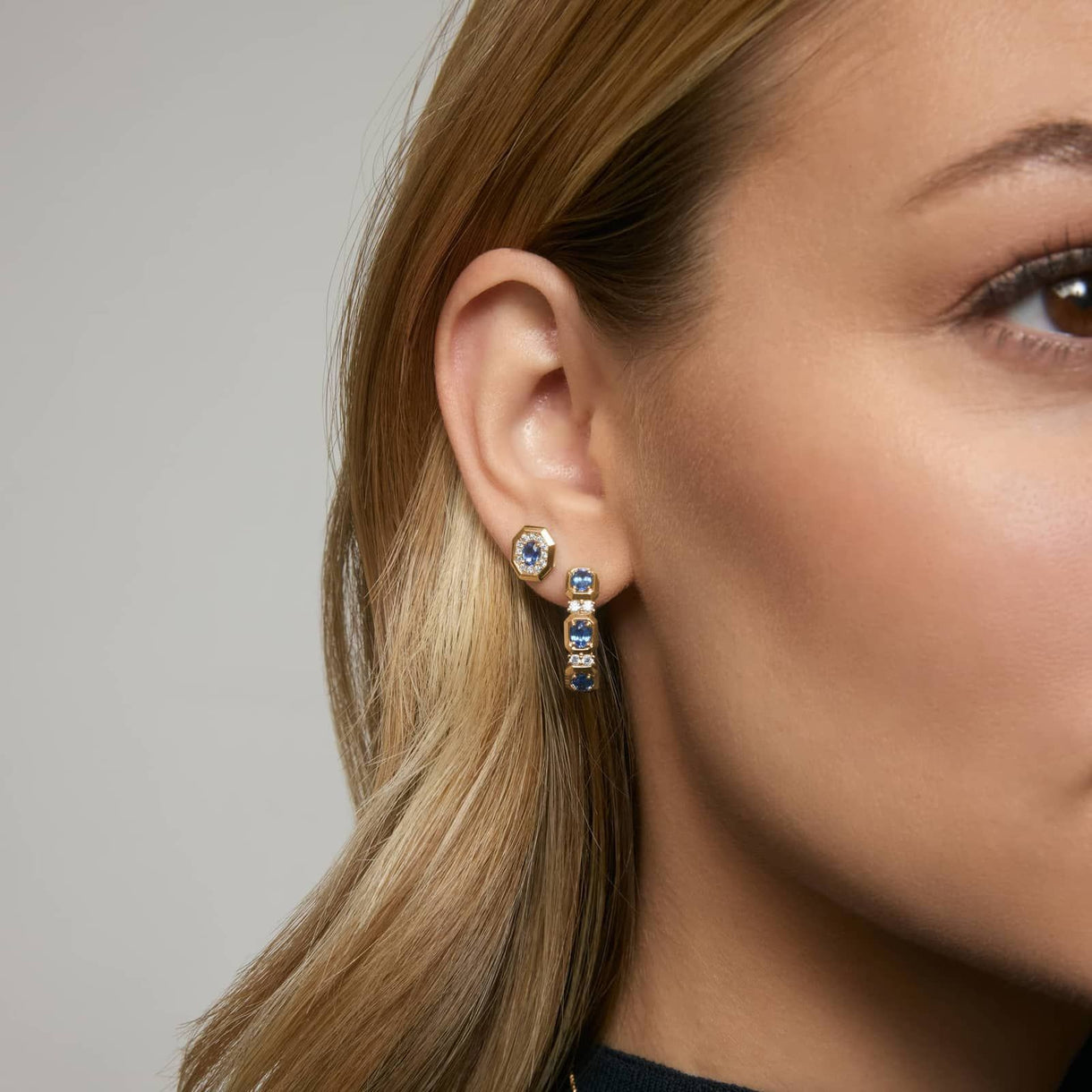 Model wearing blue sapphire earrings by Jewelhalo