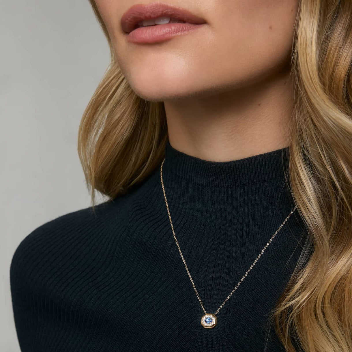 Model wearing a blue sapphire necklace by Jewelhalo