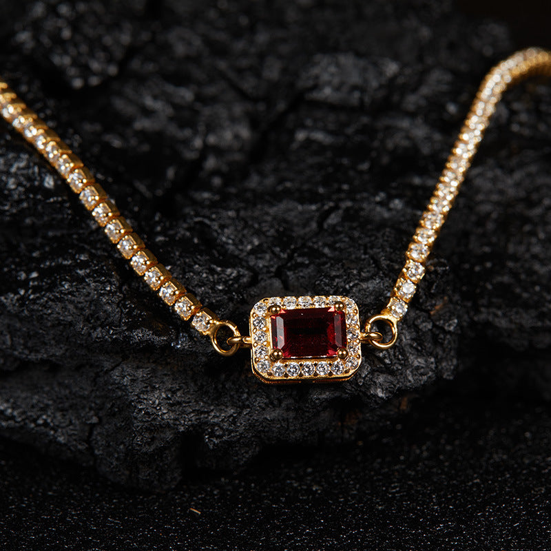 Jewelhalo gold garnet tennis bracelet on dark stone